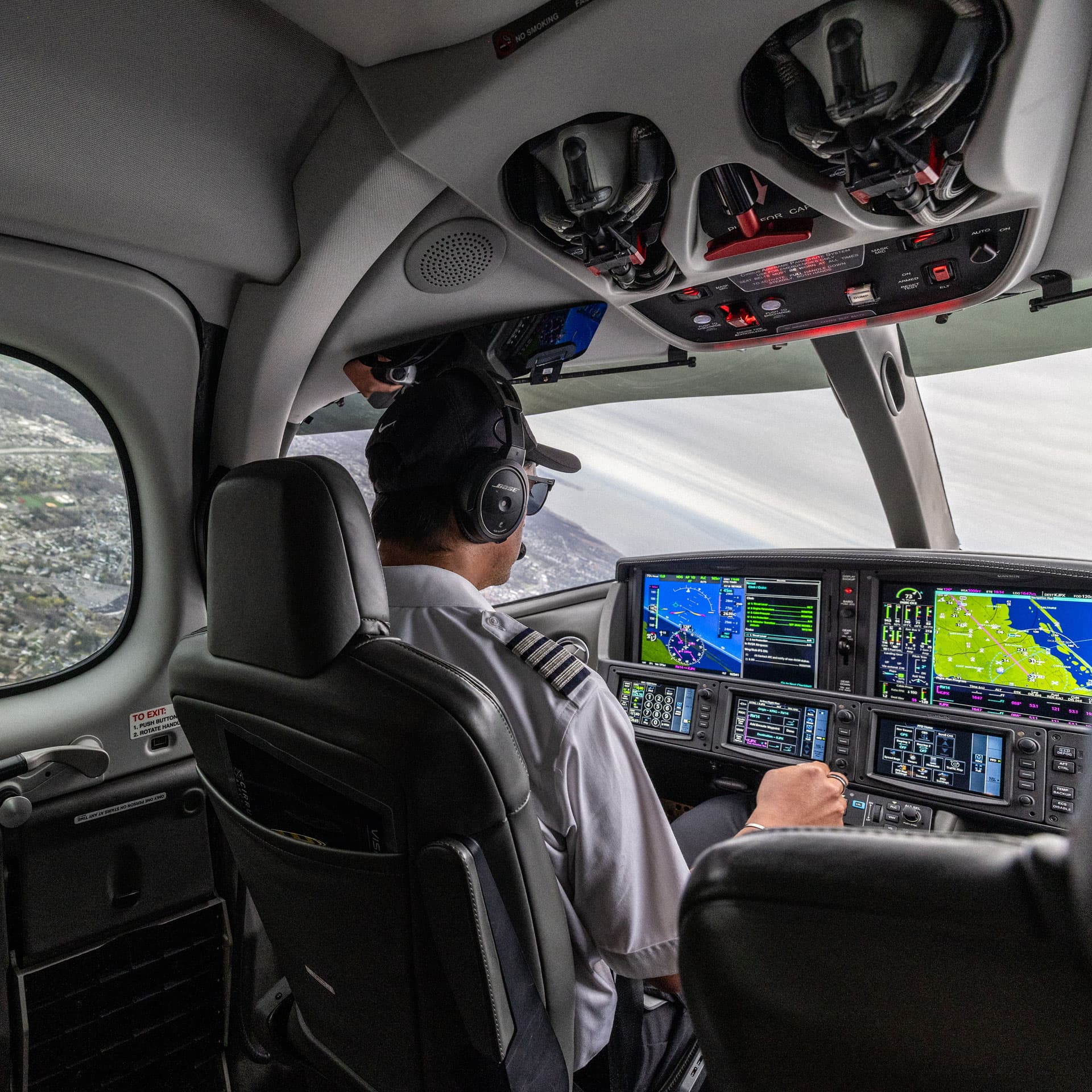 Pilot in cockpit performing safety checks